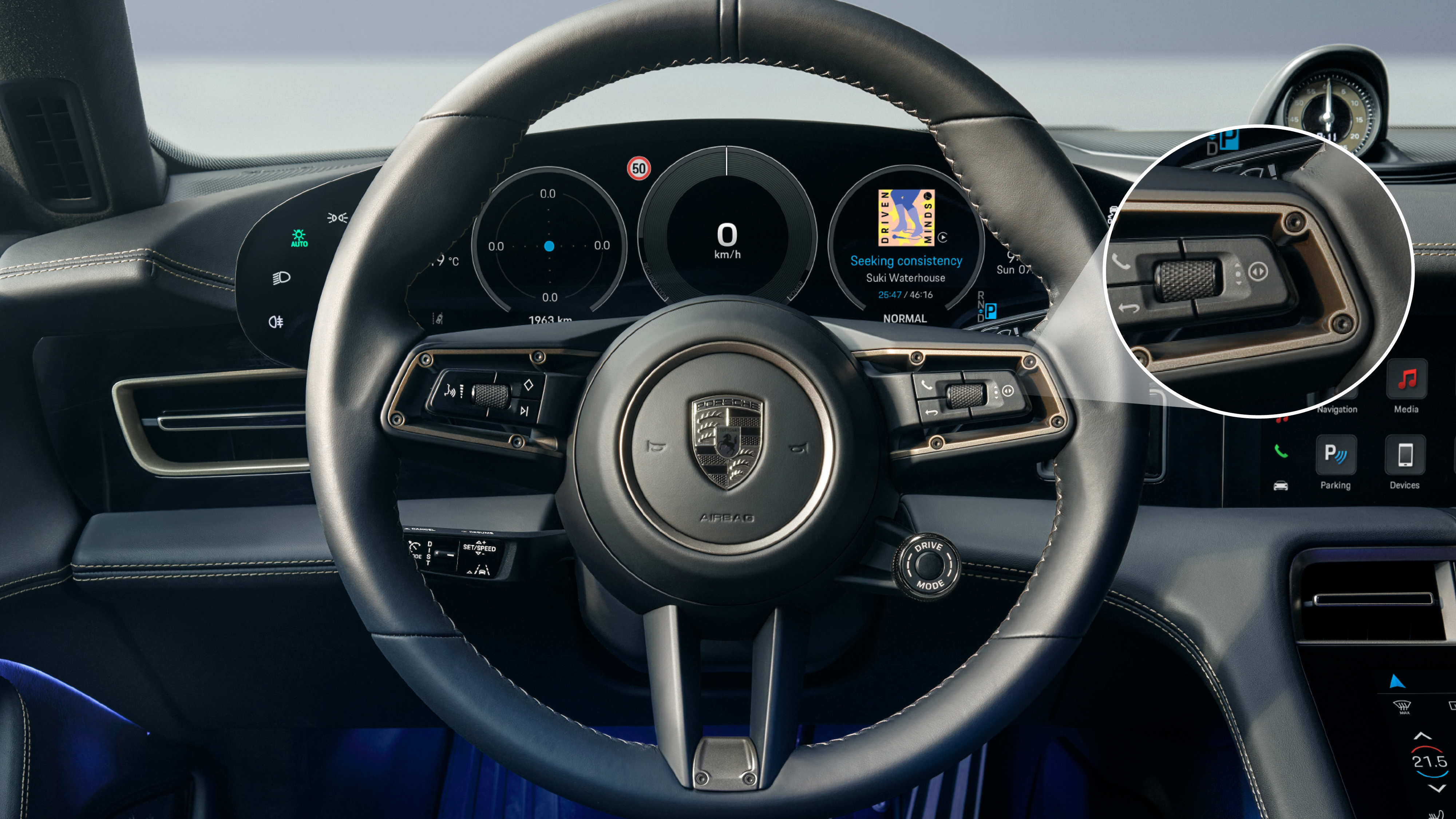 Porsche Taycan steering wheel with the right rotary toggle button highlighted.