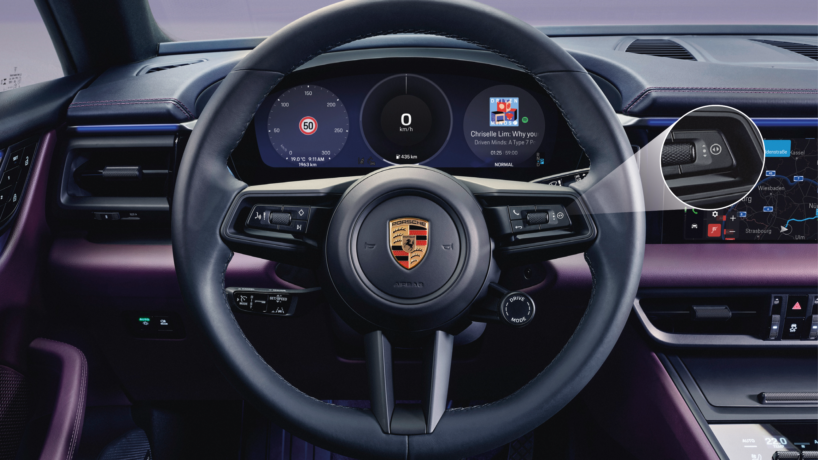 Porsche steering wheel with the right rotary toggle button highlighted.