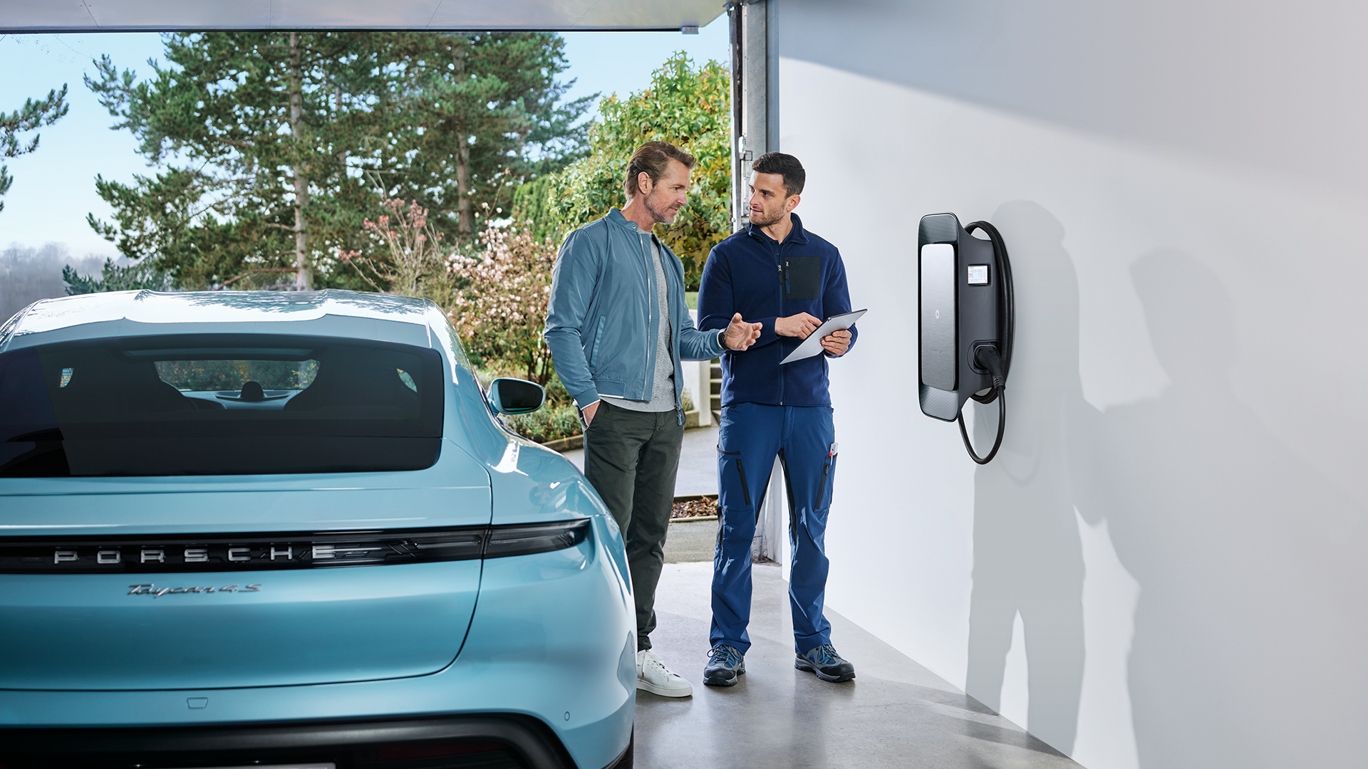 Expert installation of Porsche EV home charger with Taycan parked in garage. Professional consultation for premium electric car charging solutions, combining luxury, convenience, and sustainable mobility at home.