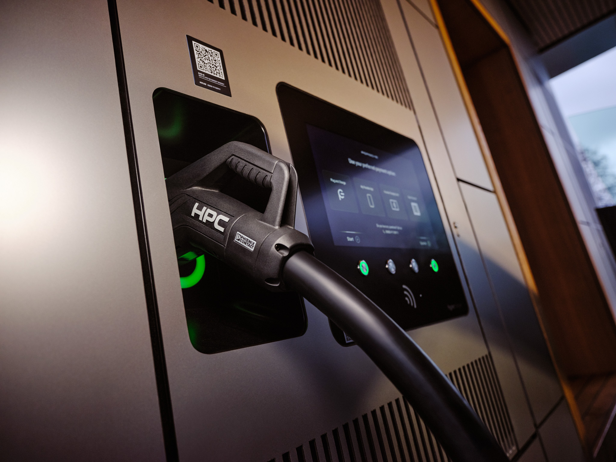 Close-up of Porsche HPC fast charger with high-power connector and digital display. Premium electric vehicle charging technology delivering ultra-fast charging for luxury EVs, supporting sustainable mobility and long-distance travel.