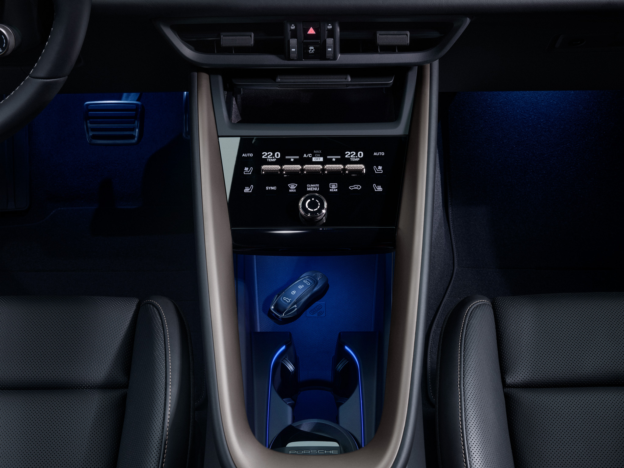 Porsche Macan interior with key and focus on the climate control in the center console.